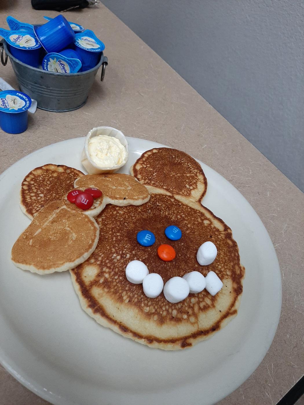 The Mickey pancake, three pancakes arranged as a face with candy eyes and a marshmallow smile